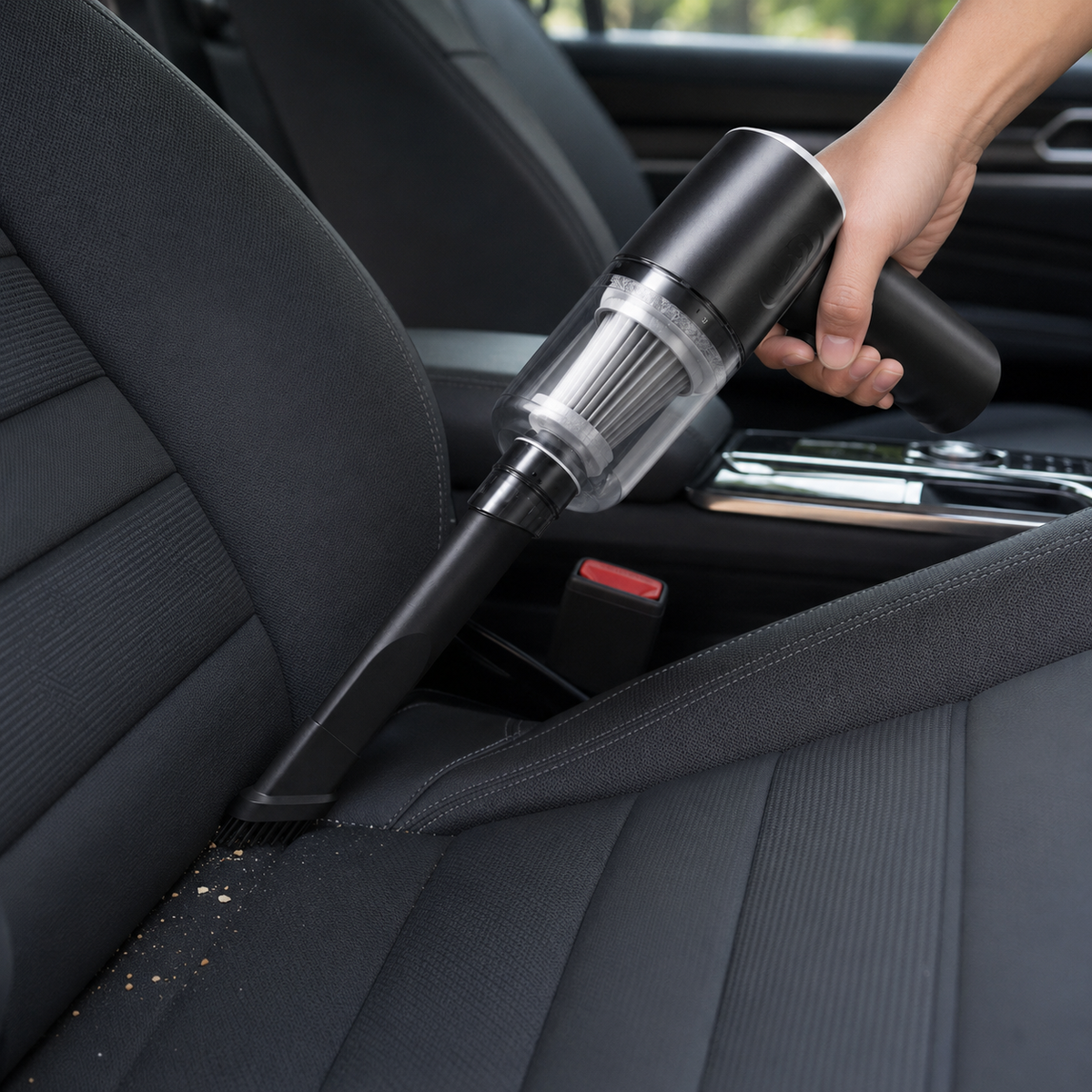 Cordless handheld vacuum cleaning a car seat