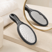 Dual-sided stainless steel foot file in a premium studio setting