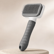 2-in-1 self-cleaning pet grooming brush in a premium studio setting
